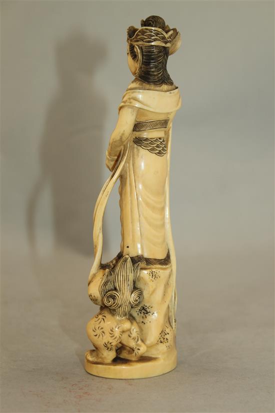 A Japanese ivory group of an immortal and a shi-shi, early 20th century, 18cm